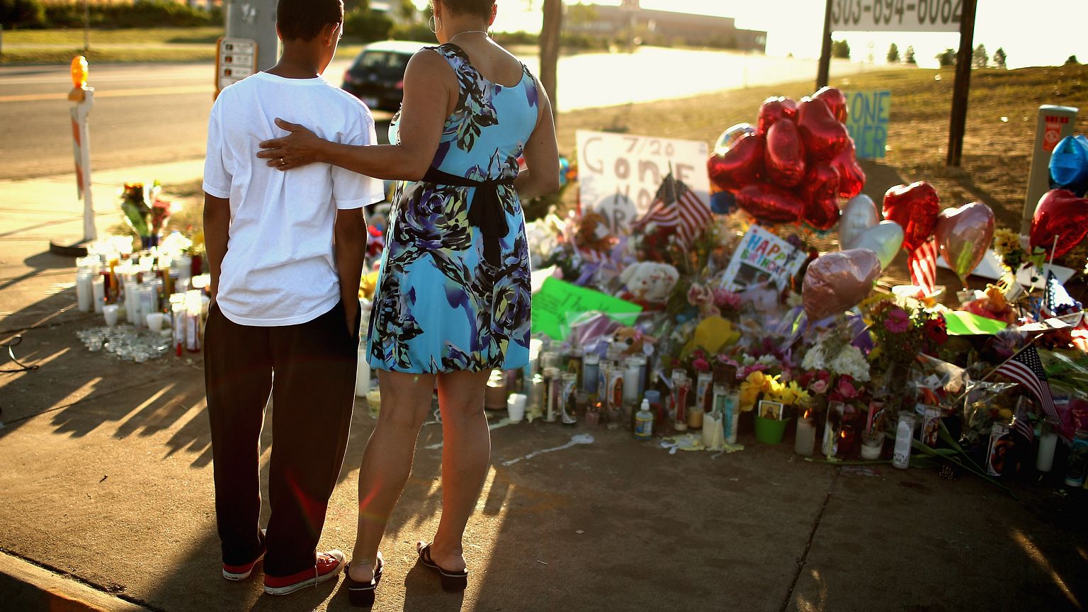 Image: Barb Whitfield and her grandson, Wanya Whitfield, visit a memorial t