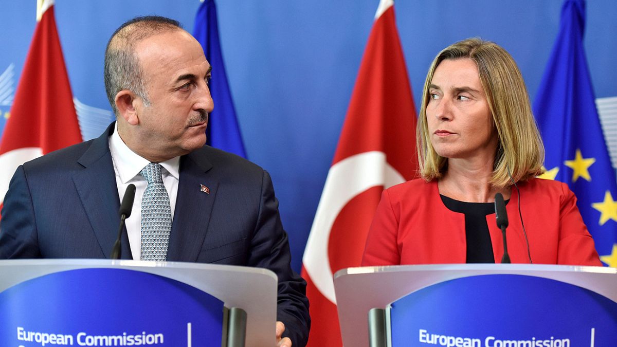 Turkish foreign minister in Brussels amid protests over activists' arrests