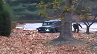 Image: A North Korean defector running out from a vehicle at the Joint Secu
