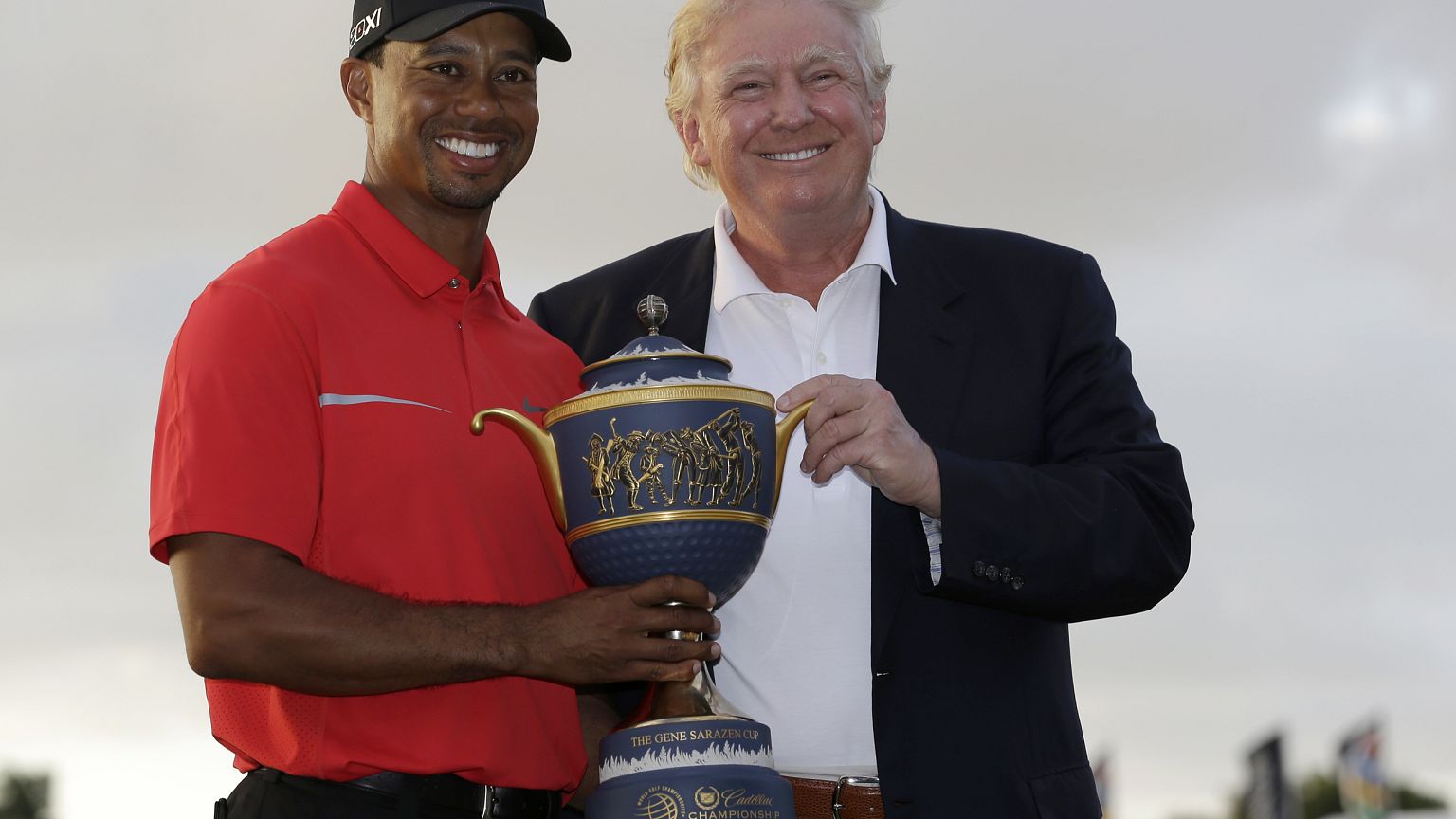 Image: Tiger Woods and Donald Trump pose for photos at the Cadillac Champio