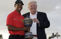 Image: Tiger Woods and Donald Trump pose for photos at the Cadillac Champio