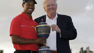 Image: Tiger Woods and Donald Trump pose for photos at the Cadillac Champio