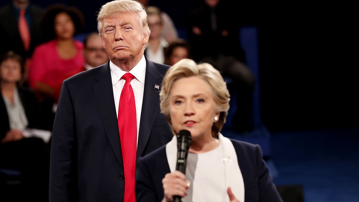 Image:Donald Trump listens as Hillary Clinton answers questions during a de