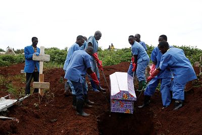 Red Cross workers carry the coffin of woman who was killed by Ebola in Butembo. 