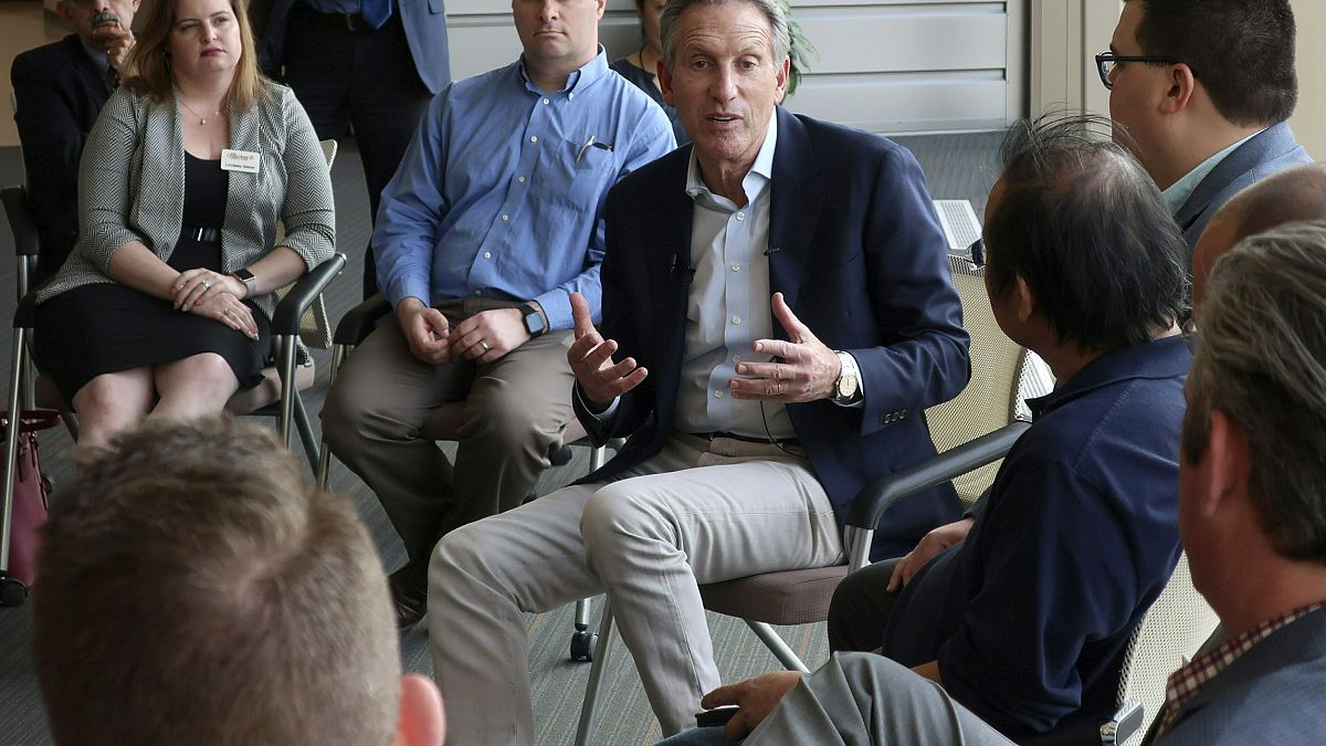 Image: Howard Schultz speaks during a town hall on the University of Kansas