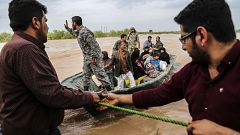Image: Iranian soldiers help civilians in a flooded village near the city o