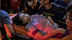 Image: Paramedics carry away an earthquake survivor in Porac