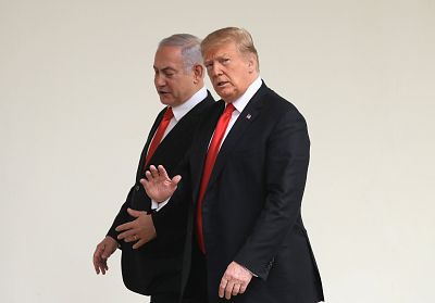 President Donald Trump and Israeli Prime Minister Benjamin Netanyahu walk through a colonnade at the White House on March 25, 2019.