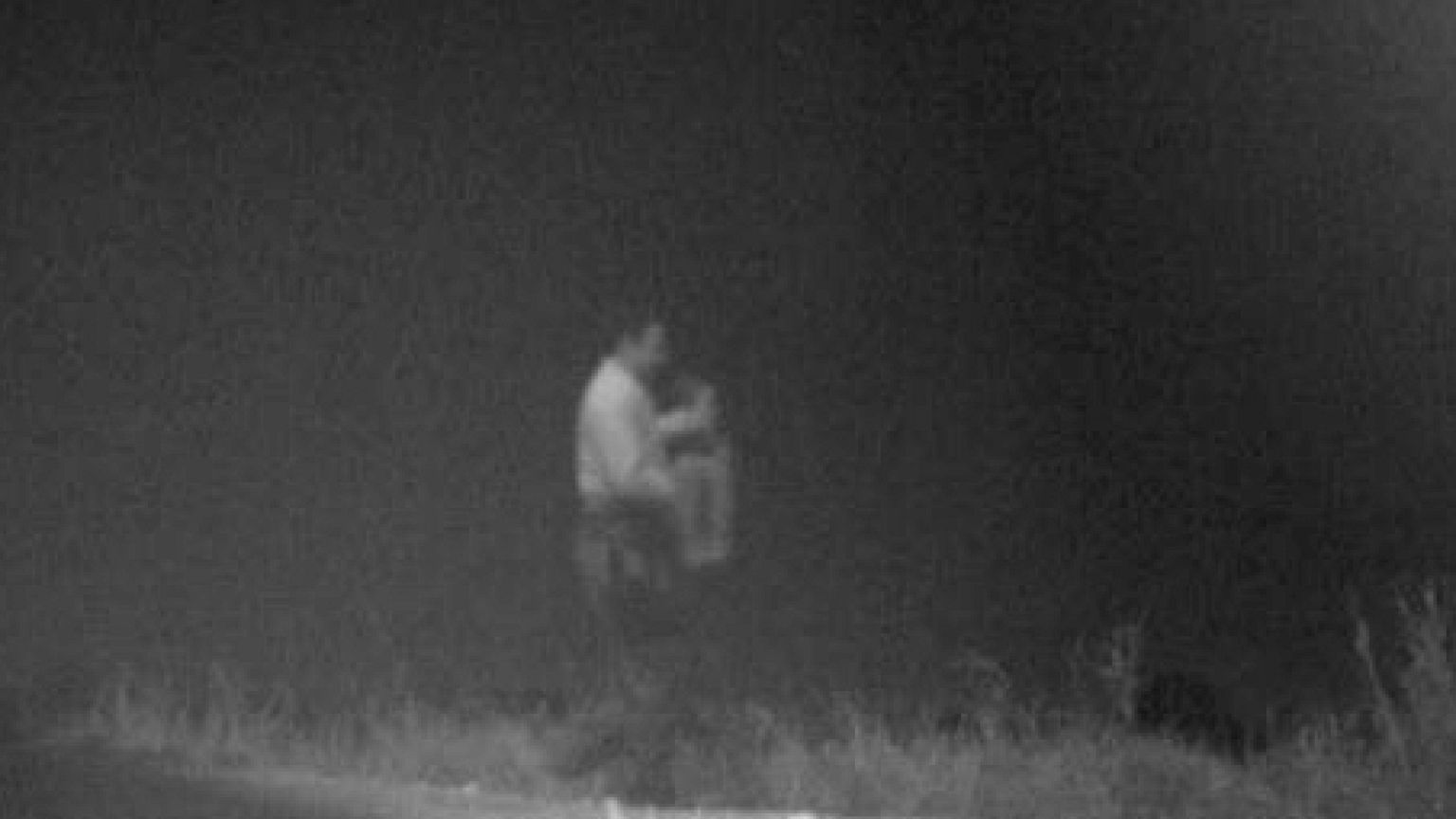 A U.S. border agent carries a three-year-old boy
