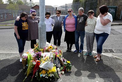 Mourners gather around a floral memorial for Lyra McKee after she was fatally shot two days earlier in Londonderry, Norther Ireland, on April 20, 2019.