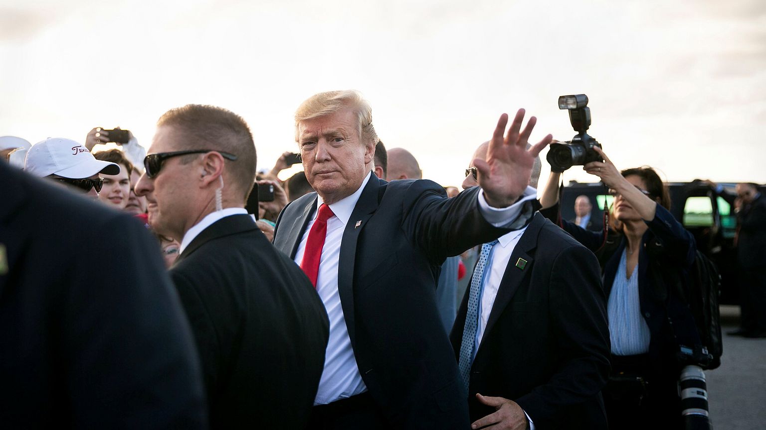 Image: U.S. President Donald Trump waves as he greets supporters on the tar