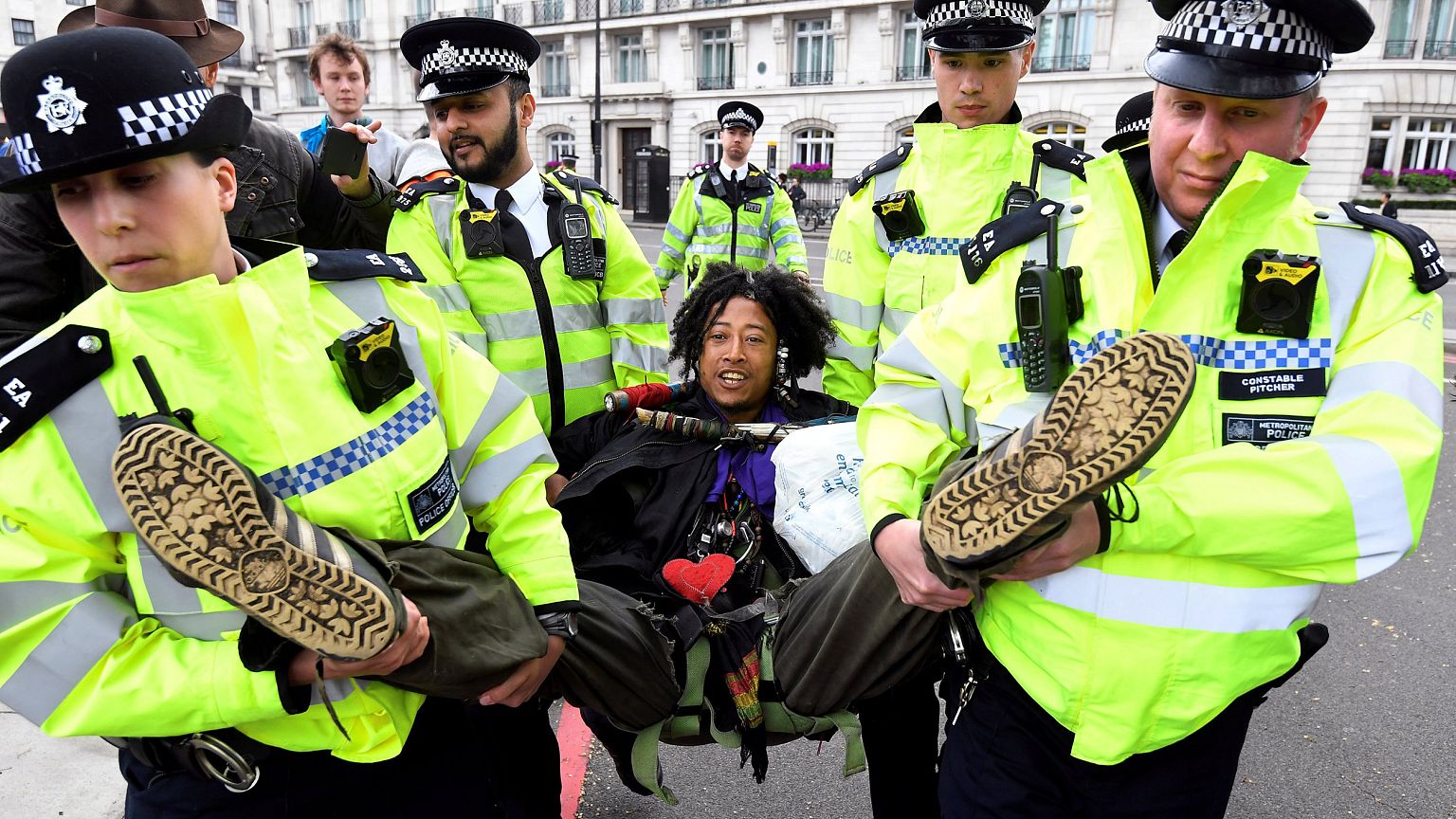Image: Members of the police carry a demonstrator during the Extinction Reb