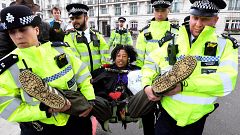 Image: Members of the police carry a demonstrator during the Extinction Reb