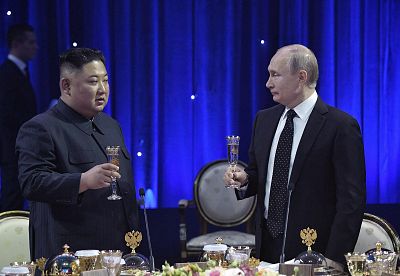 Putin and Kim share a toast.