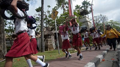 Duck and cover: Indonesian children take part in tsunami drill