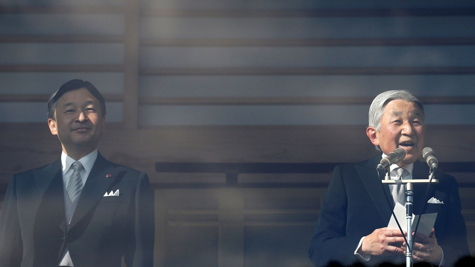 Image: Japanese Emperor Akihito, right, makes a speech as Crown Prince Naru