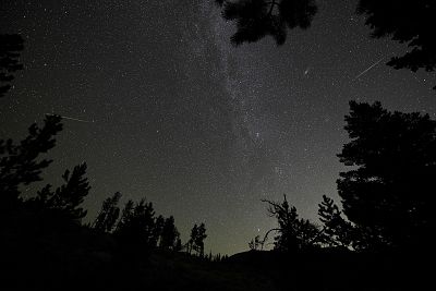 Two Perseid meteors near the Andromeda Galaxy, 2nd right and the Milky Way, center, over Rocky Mountain National Park in Colorado in the early morning hours of Aug. 12, 2018. The annual Perseid meteor shower is expected to peak in the early hours of August 13.
