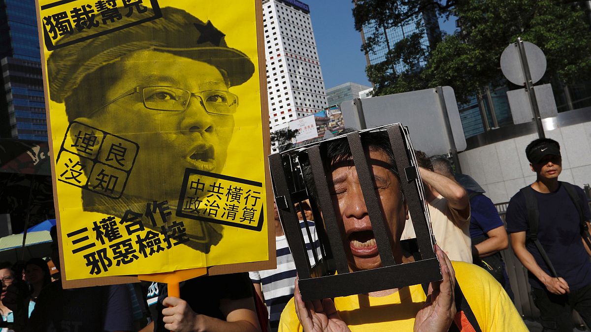 Tens of thousands protest jailing of Hong Kong democracy leaders