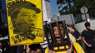 Tens of thousands protest jailing of Hong Kong democracy leaders