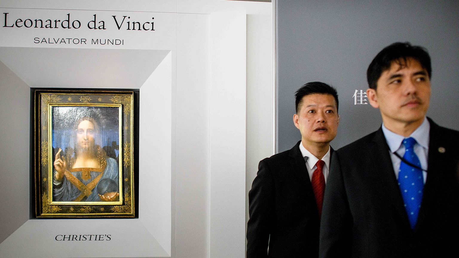 Image: A man (right, wearing blue tie) identified by local Hong Kong media 