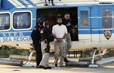 Najibullah Zazi is escorted by U.S. Marshals after a helicopter landing at a New York Police Department facility in Brooklyn, New York, on Sept. 25, 2009.