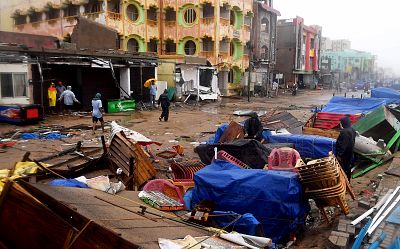 Indian residents inspect damages on street stalls at a promenade after Cyclone Fani landfall in Puri in the eastern Indian state of Odisha on May 3, 2019.