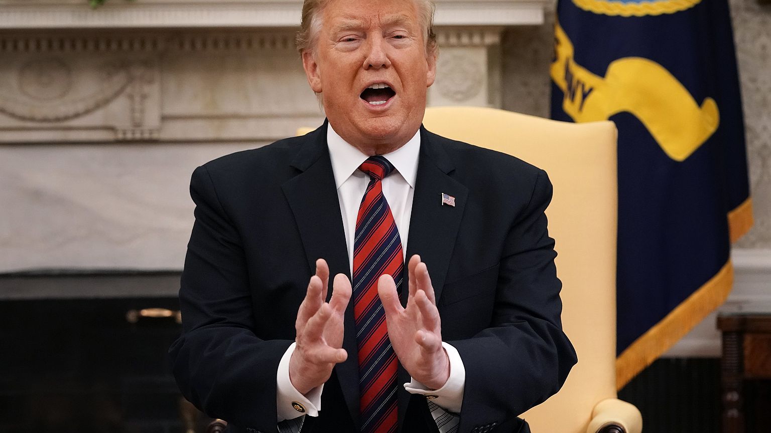 President Donald Trump talks to reporters in the Oval Office