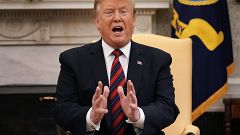 President Donald Trump talks to reporters in the Oval Office