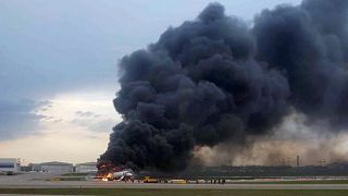 Image: A passenger plane is seen on fire after an emergency landing at the