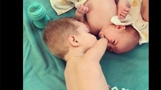 طفل فاقد لذراعيه يساعد أخاه الرضيع