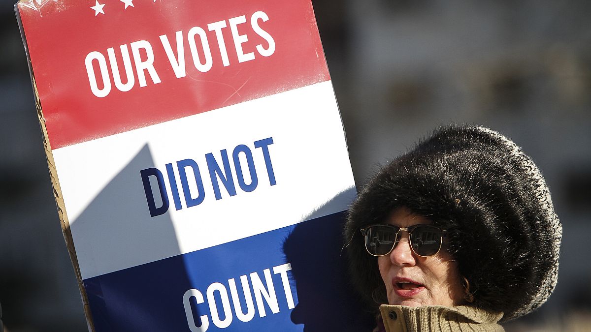 A protester at a rally at the Michigan State Capitol before the state elect