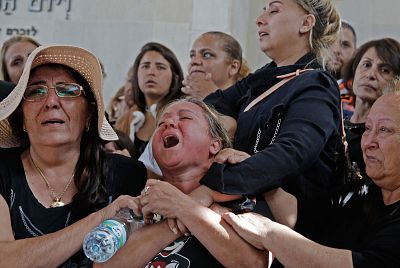 Friends and relatives mourn during the funeral of Moshe Agadi on Sunday. Agadi is an Israeli man who was killed after a rocket fired from Gaza hit his house in the southerm city of Ashkelon.