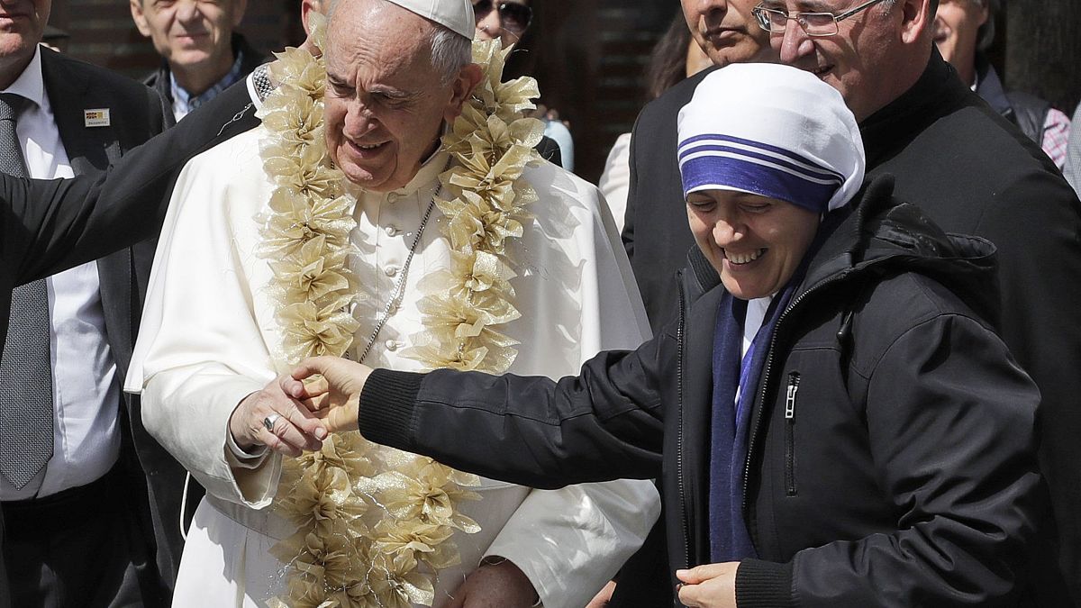 Image: Pope Francis is welcomed by a nun as he arrives at Mother Teresa's m