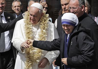 Pope Francis is welcomed by a nun as he arrives at Mother Teresa\'s memorial in Skopje, North Macedonia, on Tuesday.