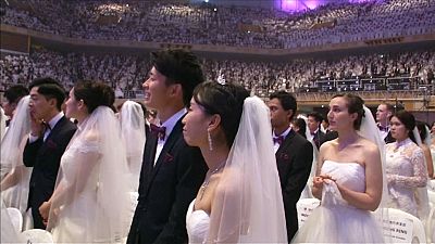 Unification church couples over the moon at mass wedding