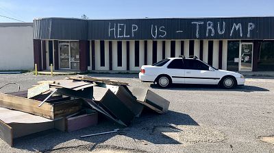 An abandoned storefront in Panama City Beach, Florida, features a message for President Trump, who is set to visit the hurricane-torn region on May 8, 2019.