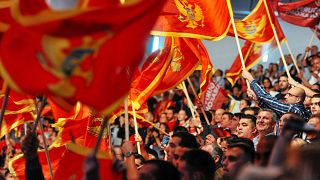 Image: Supporters of Montenegrin Prime Minister Milo Djukanovic wave flags 