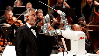 Robot conductor shares stage with Italian tenor Andrea Bocelli