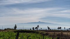 Image: Mt. Kenya peeks out from the clouds beyond a small farm in Embaringo