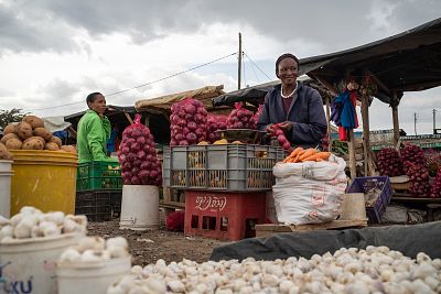 Eunice Ngima runs a small roadside stall selling garlic, onions, potatoes and other vegetables in Kiawara, Kenya.