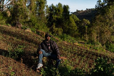 Garlic farmer Peter Munene Ndururi rests in his field in Embaringo, Kenya.