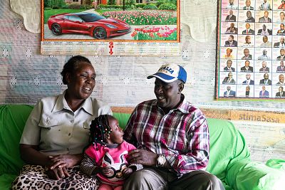 Charles Gichuhi Ngari sits with his wife, Esther Wairimu Gichuhi, and granddaughter Rose Wamboi Njoroge at their home in Embaringo, Kenya.