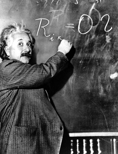 Dr. Albert Einstein writes out an equation for the density of the Milky Way on the blackboard at the Carnegie Institute, Mt. Wilson Observatory headquarters in Pasadena, California on Jan. 14, 1931.