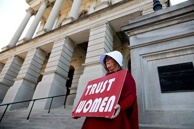 Michelle Disher, dressed as a Handmaid, protests Georgia\'s anti-abortion "heartbeat" bill at the State Capitol in Atlanta on May 7, 2019.
