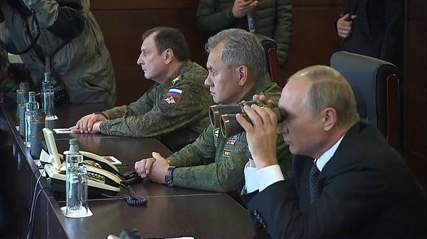 Vladimir Putin looks on as Russia flexes its military muscles Vladimir Putin looks on as Russia flexes its military muscles