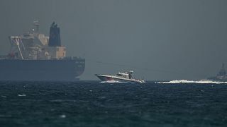 Image: A coast guard vessel passes an oil tanker off the coast of Fujairah,