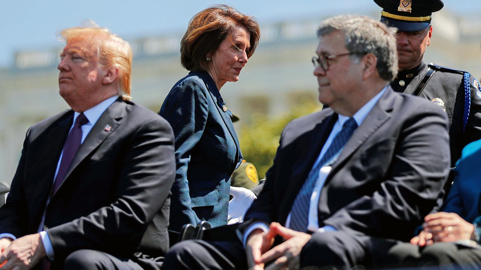 Image: Speaker of the House Pelosi walks behind President Trump and Attorne
