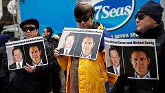 Image: People hold placards calling for China to release Canadian detainees