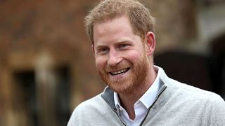 Image: Britain's Prince Harry, Duke of Sussex, speaks to members of the med