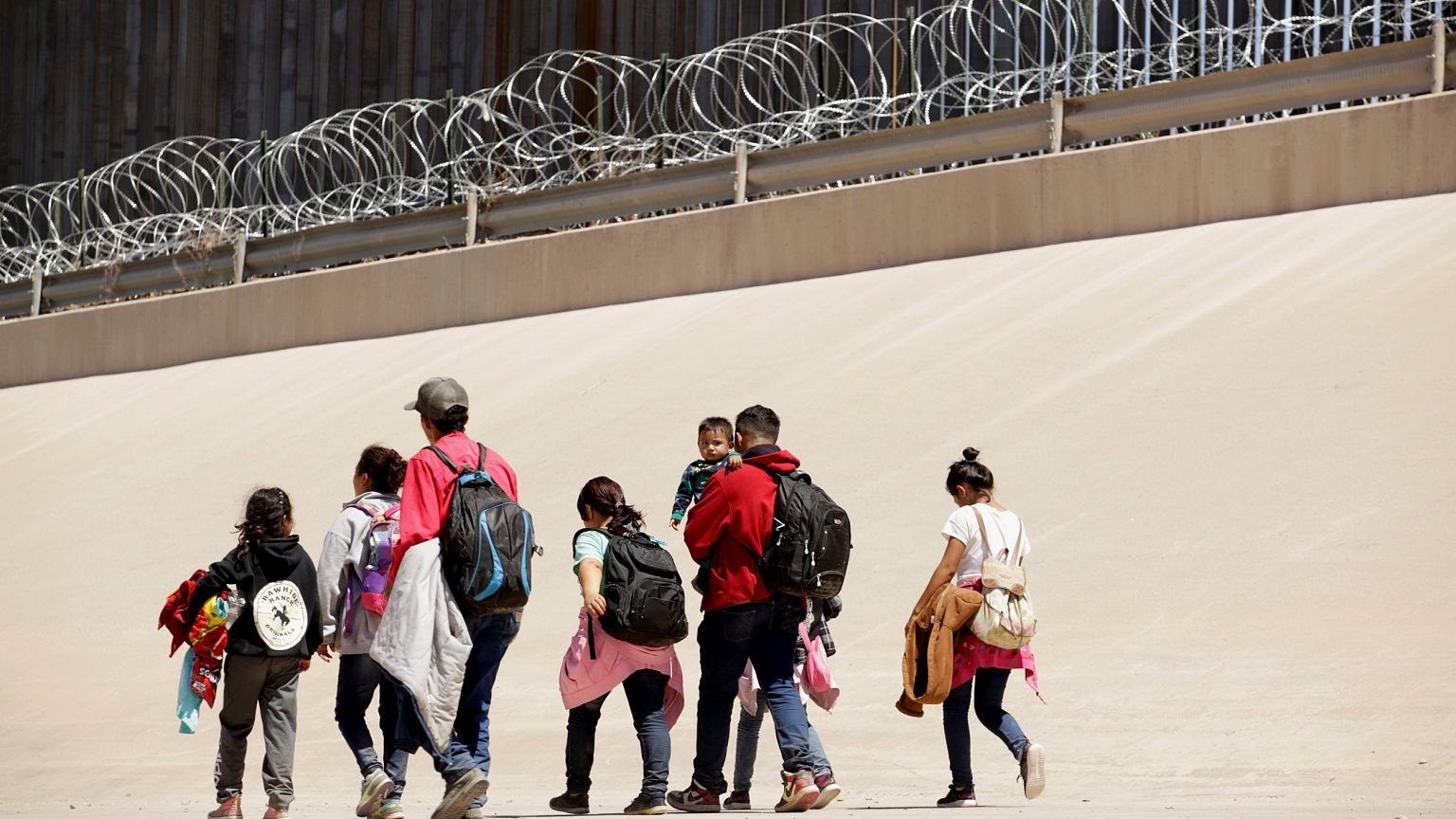 Image: Migrants walk near the border between Ciudad Juarez, Mexico, and El 